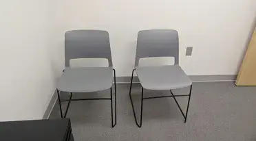 Kansas City, MO: Primary Care Office Furniture Installation Creates a Professional Patient Environment Two gray guest chairs against a white office wall